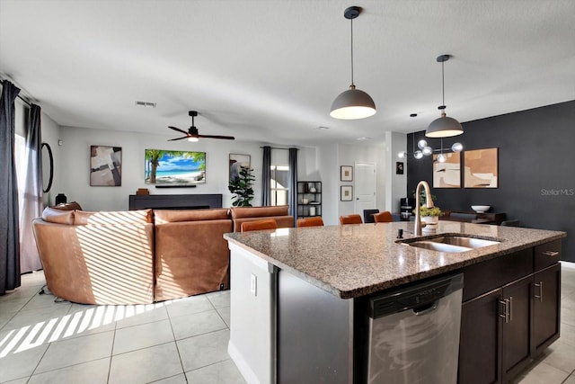 kitchen with a center island with sink, sink, ceiling fan, appliances with stainless steel finishes, and light stone counters