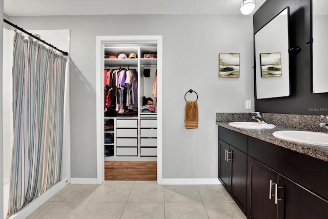 bathroom with tile patterned flooring, a shower with curtain, and vanity