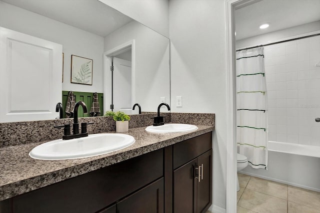 full bathroom with tile patterned floors, vanity, toilet, and shower / bath combo with shower curtain