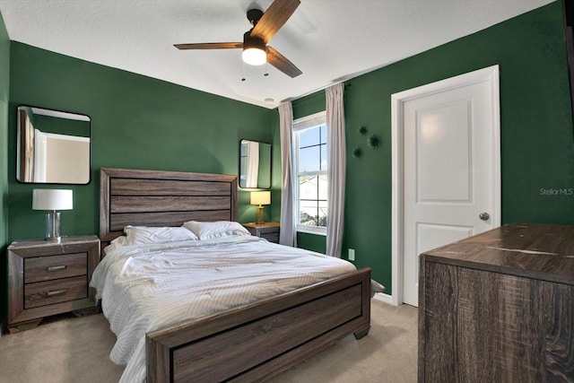 bedroom with light carpet and ceiling fan