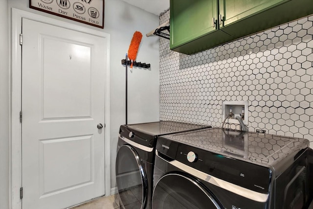 laundry area with cabinets, separate washer and dryer, and light tile patterned flooring