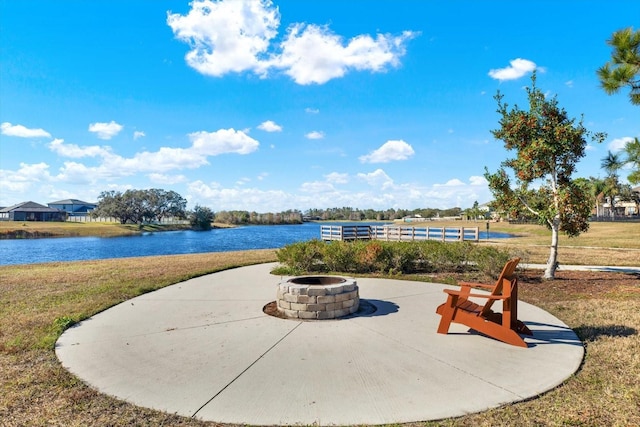 view of patio featuring a water view and a fire pit