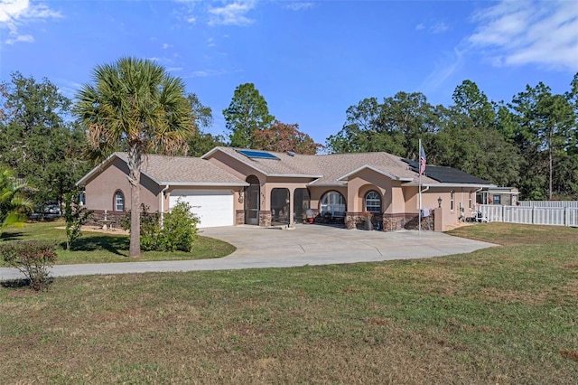 ranch-style home with a front yard, solar panels, and a garage