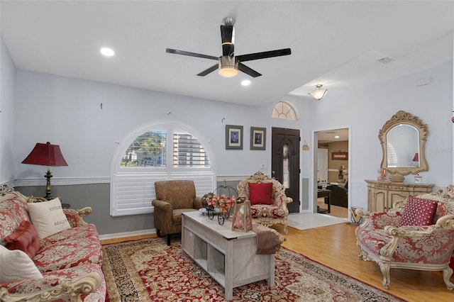 living room featuring light hardwood / wood-style floors and ceiling fan