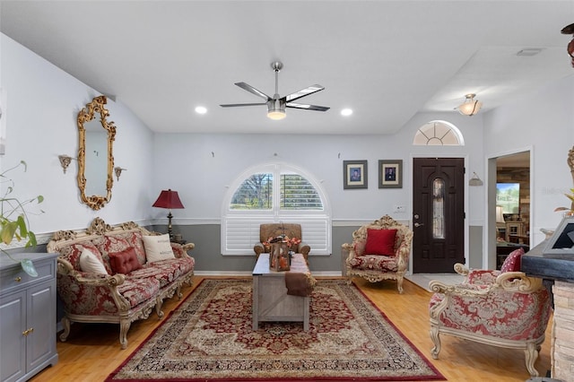 living room featuring ceiling fan and light hardwood / wood-style flooring