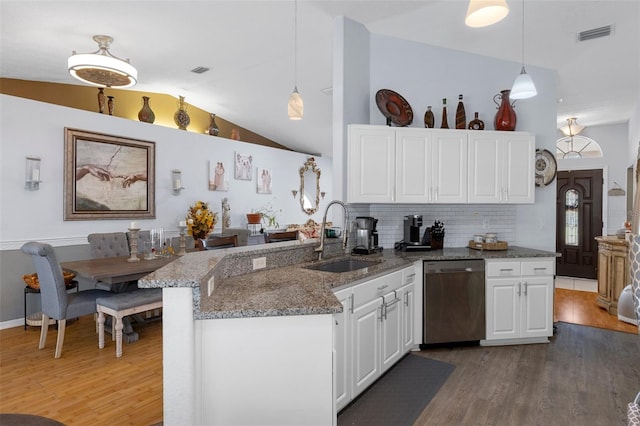 kitchen with white cabinets, sink, stainless steel dishwasher, decorative backsplash, and decorative light fixtures