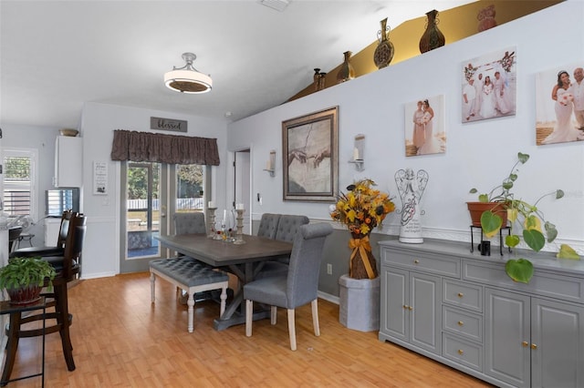 dining space with light wood-type flooring and a wealth of natural light