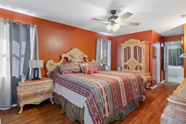 bedroom featuring ensuite bath, ceiling fan, and wood-type flooring