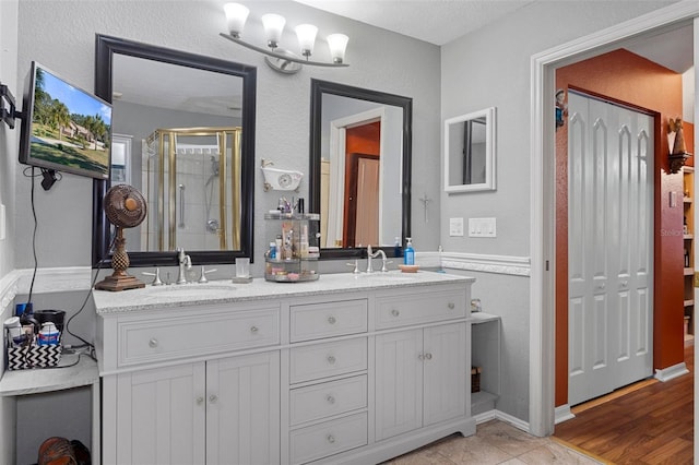 bathroom featuring tile patterned floors, vanity, and walk in shower