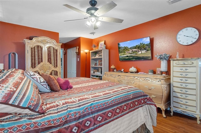 bedroom with light wood-type flooring and ceiling fan