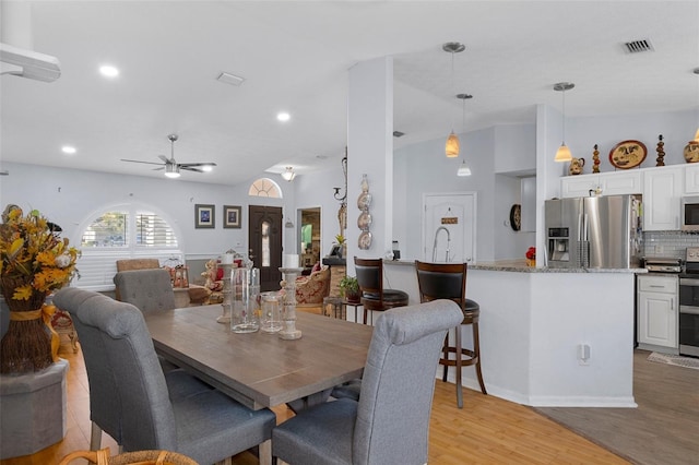 dining room featuring light wood-type flooring and ceiling fan