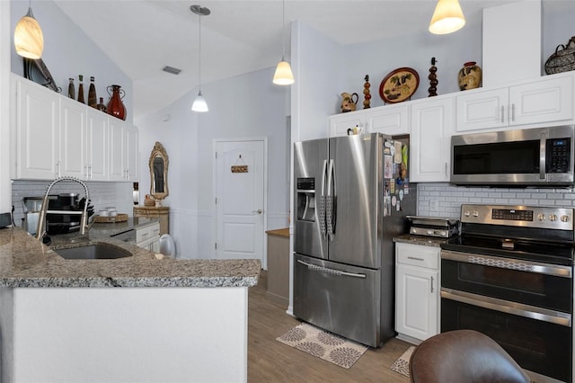 kitchen with white cabinets, stainless steel appliances, tasteful backsplash, and sink