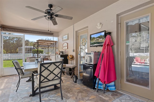 sunroom / solarium with ceiling fan