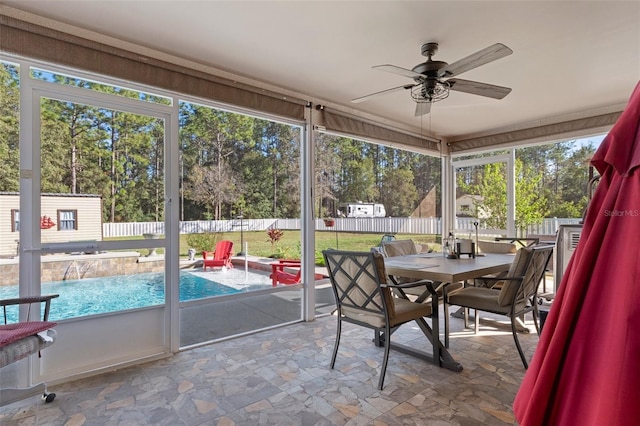 sunroom / solarium featuring ceiling fan