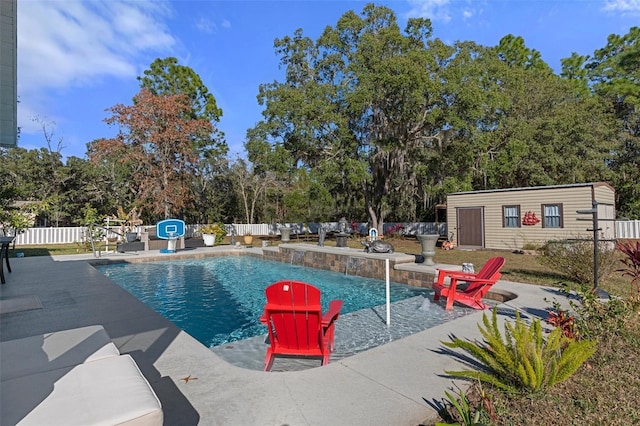 view of swimming pool with a patio, pool water feature, and an outdoor structure