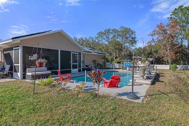 view of pool with a lawn, a sunroom, and a patio