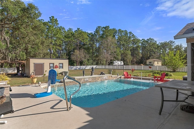 view of pool with pool water feature, a patio area, an outdoor structure, and a yard