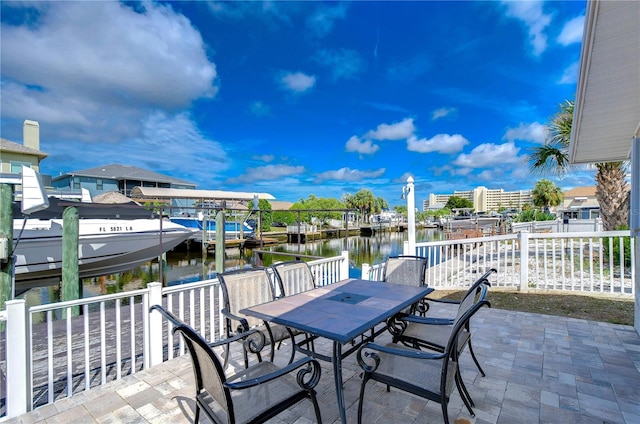 view of patio with a boat dock and a water view