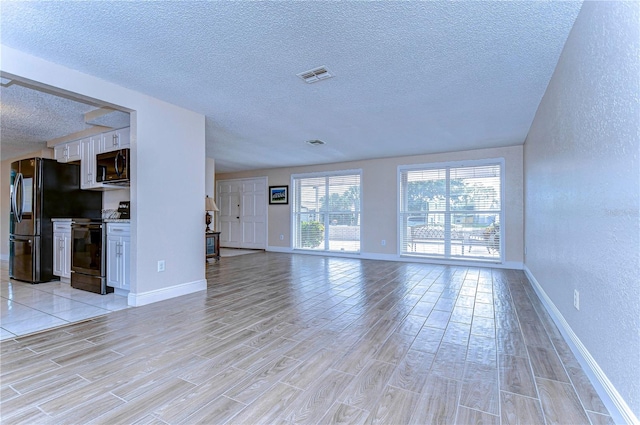 unfurnished living room with a textured ceiling