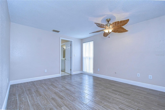 spare room featuring ceiling fan and a textured ceiling