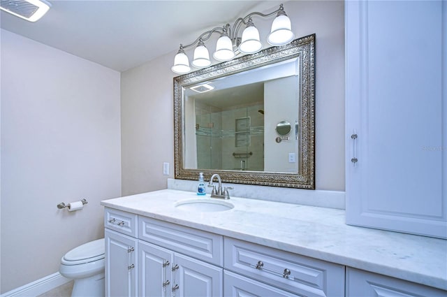 bathroom featuring vanity, toilet, and a shower with shower door