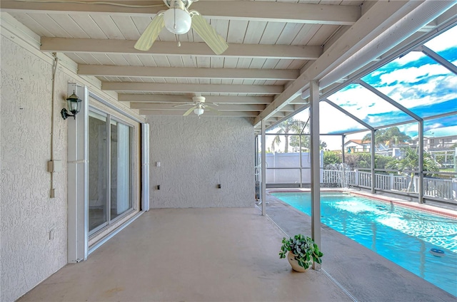 view of pool featuring a patio area, ceiling fan, and a lanai