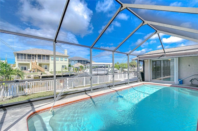 view of swimming pool featuring glass enclosure