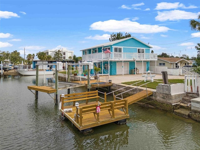 dock area with a patio area and a water view