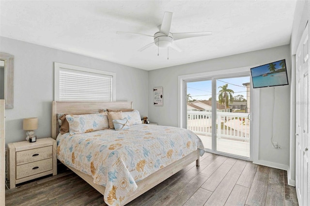 bedroom with access to exterior, dark hardwood / wood-style flooring, and ceiling fan