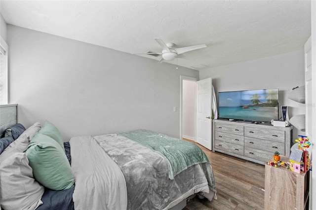 bedroom with ceiling fan and dark hardwood / wood-style floors