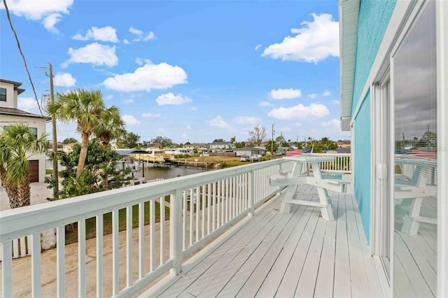 wooden terrace featuring a water view