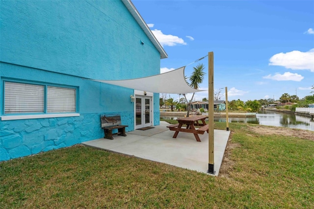 view of patio / terrace with french doors and a water view