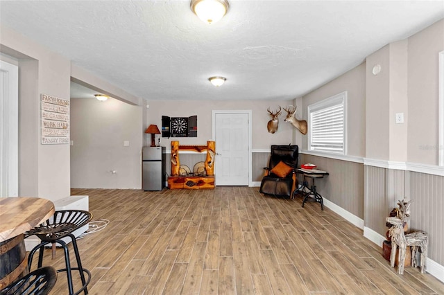 miscellaneous room with wood-type flooring and a textured ceiling