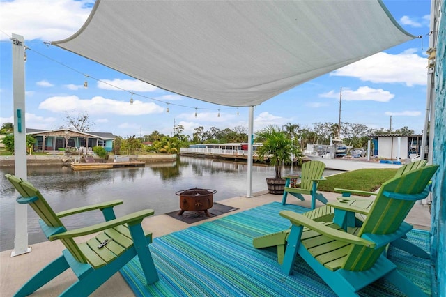 dock area with a water view, a patio, and an outdoor fire pit