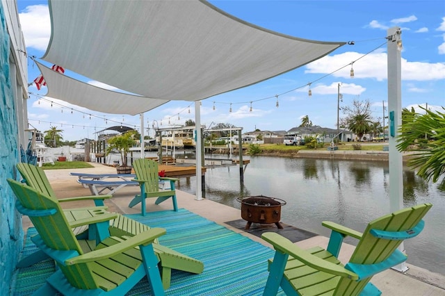 dock area with a water view and an outdoor fire pit