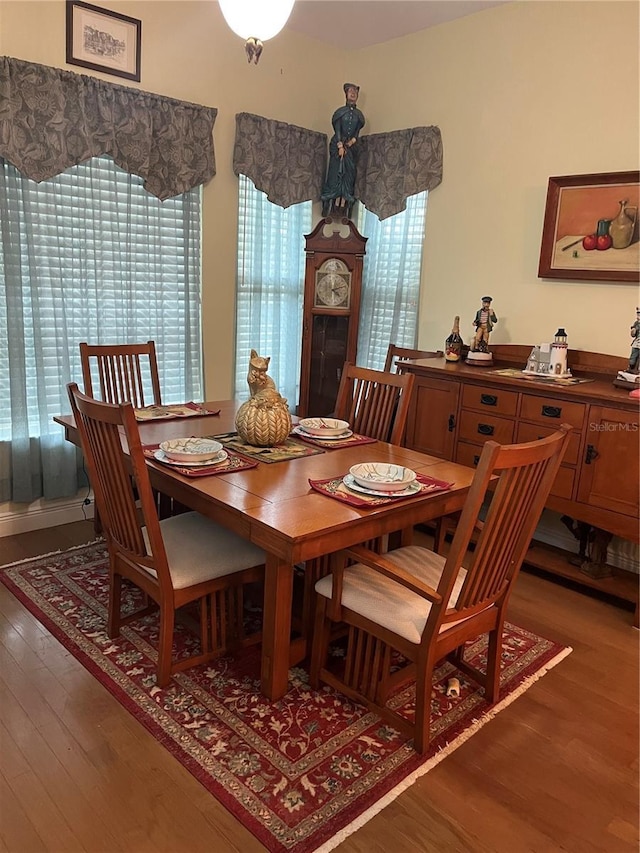 dining space with dark wood-type flooring