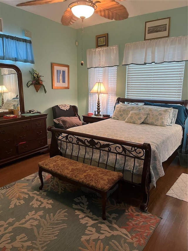 bedroom featuring ceiling fan and dark hardwood / wood-style floors