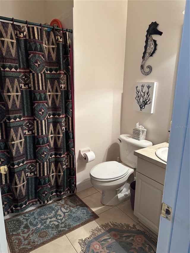 bathroom featuring tile patterned flooring, vanity, a shower with shower curtain, and toilet