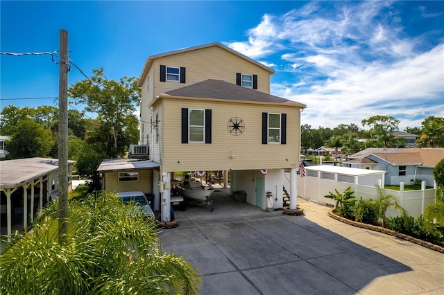 back of property featuring cooling unit and a carport