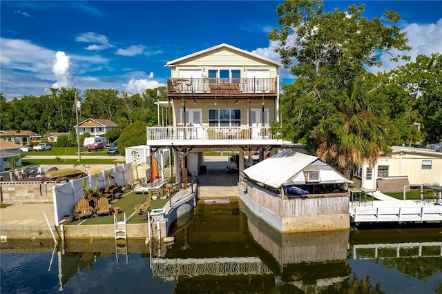 back of house featuring a balcony and a water view