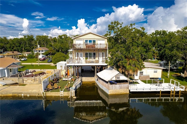 rear view of property with a patio, a water view, and a balcony