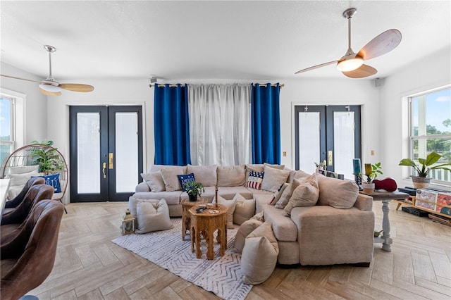 living room featuring french doors, light parquet floors, and a wealth of natural light