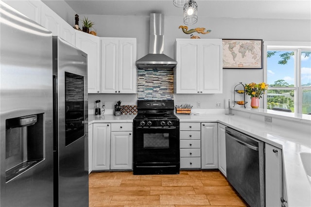 kitchen with white cabinetry, wall chimney range hood, stainless steel appliances, and tasteful backsplash