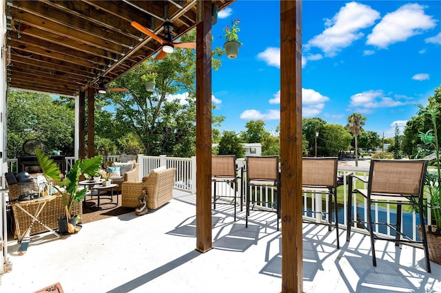 view of patio / terrace with ceiling fan and an outdoor living space