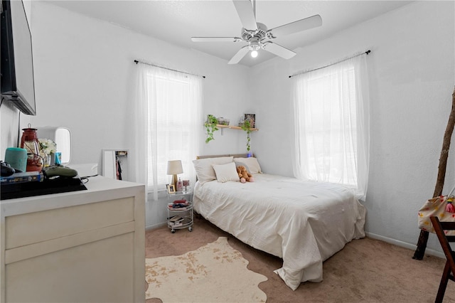 bedroom featuring ceiling fan and light carpet