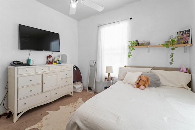 bedroom with ceiling fan and light colored carpet