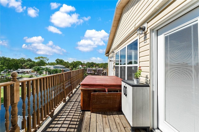 wooden terrace featuring a hot tub