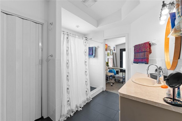 bathroom featuring vanity, curtained shower, plenty of natural light, and tile walls