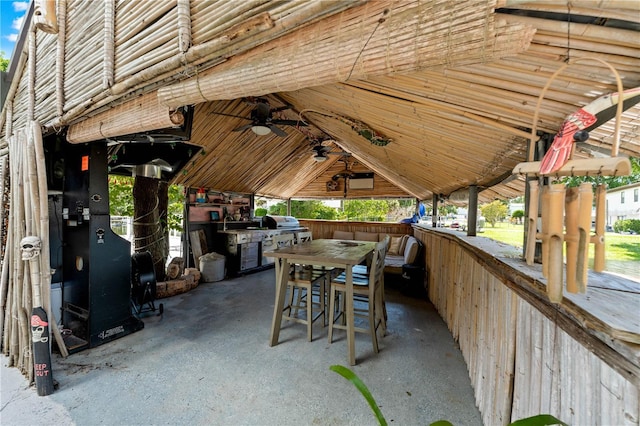 view of patio / terrace with ceiling fan and an outdoor bar