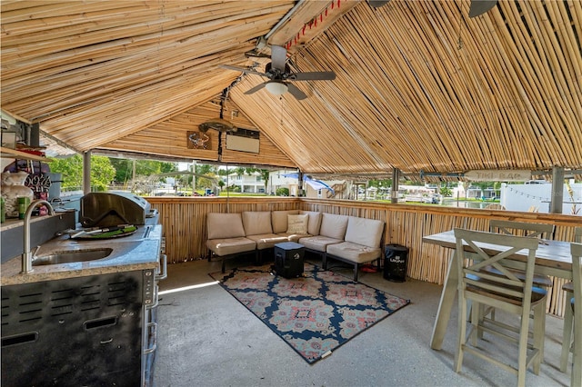 view of patio featuring grilling area, sink, and an outdoor hangout area